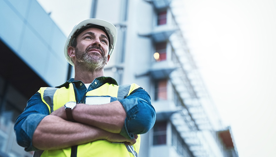 Man in front of office building empowered by capital planning software
