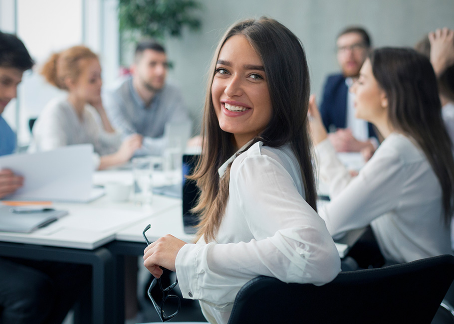 Capital Planning Software Business Lady in meeting room with colleagues happy with Capital Planning Software integration with CapEx Management